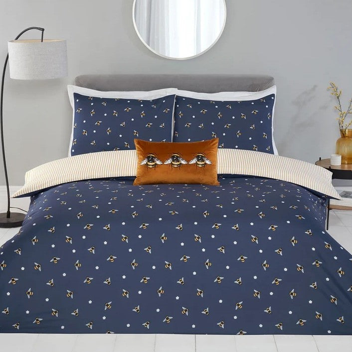 Navy blue duvet cover with an all over print of bees and daisy flowers