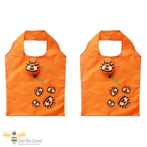 Two orange foldable shopping bags with bee designs and carry pouch.