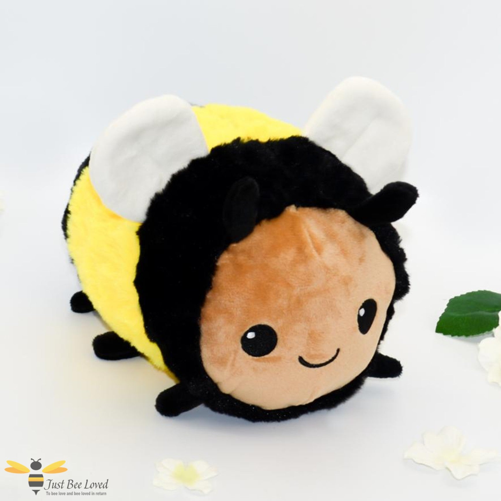 A small sized plush soft toy bee with a smiling face.