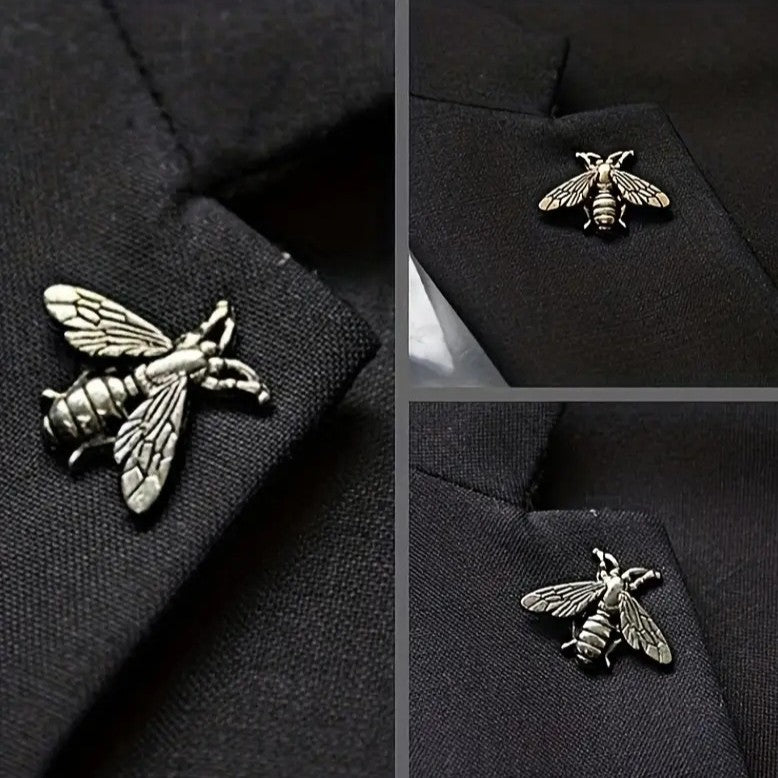 Silver bee-shaped lapel pin on a black suit jacket