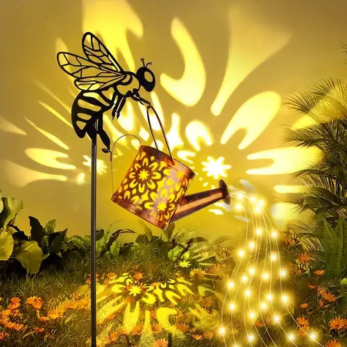 Solar garden light shaped like a bee with a watering can lantern, casting a light of a flower.