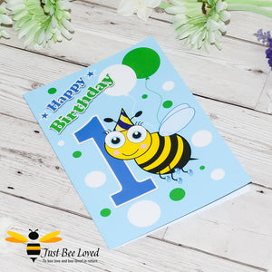 image of a blue 1st birthday bee greeting card featuring a cartoon illustration of an infant bee in a party hat next to the number 1.