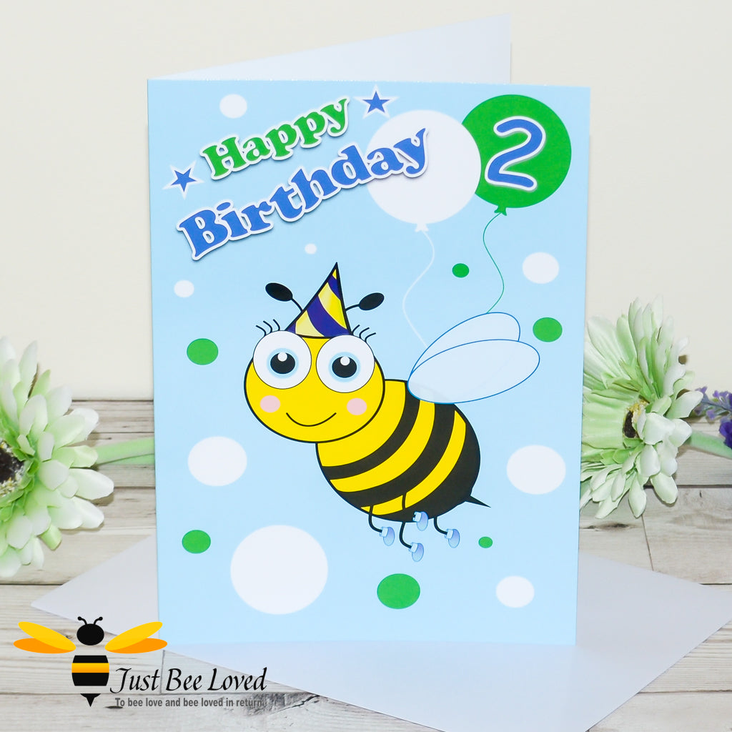A colourful birthday greeting card with a cartoon bee design, balloon with the number 2, and birthday greetings. Includes a white envelope.