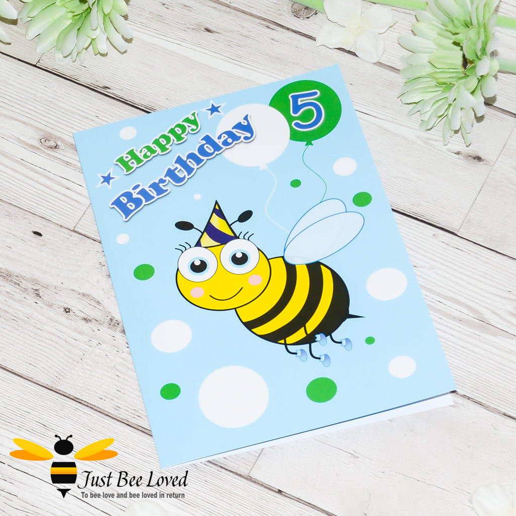 a bee themed birthday card for a 5 year old, featuring a cartoon illustration of a bee wearing a party hat and holding a balloon with the number 5 on a blue background.