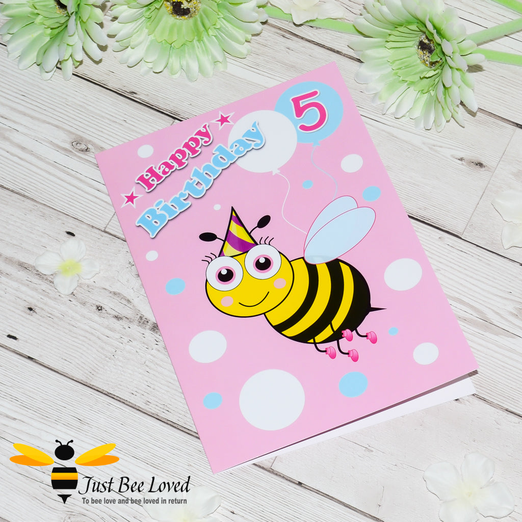 A colourful birthday greeting card featuring a cartoon bee design with the number 5, with 'Happy Birthday', on a pink background. 