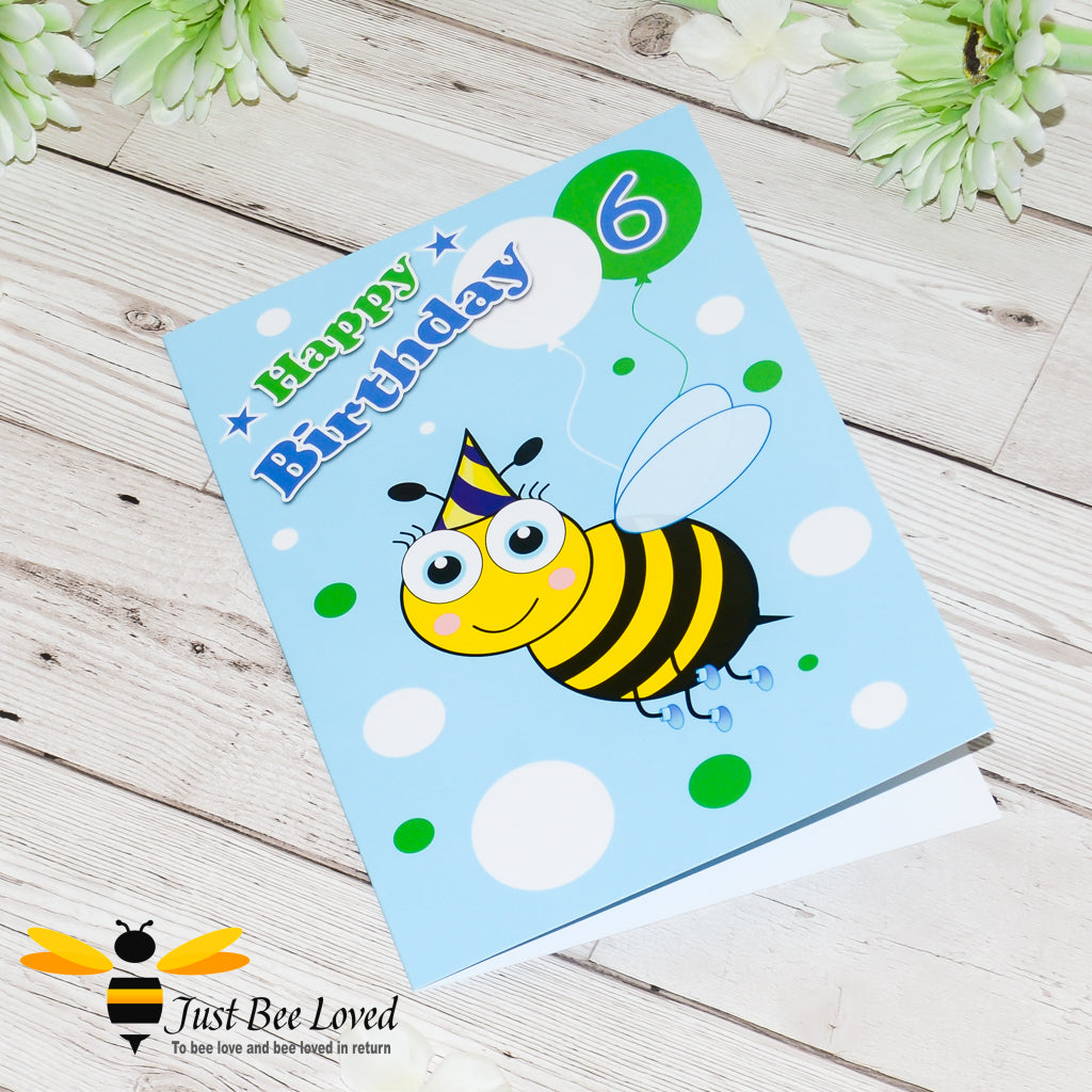 a blue bee themed birthday bee card with a cartoon illustration of a bee wearing a party hat and holding a balloon with the number 6.