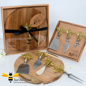Acacia wood round cheese board with stainless steel spreader featuring a brass bee handle and matching 3 piece cheese knife gift set