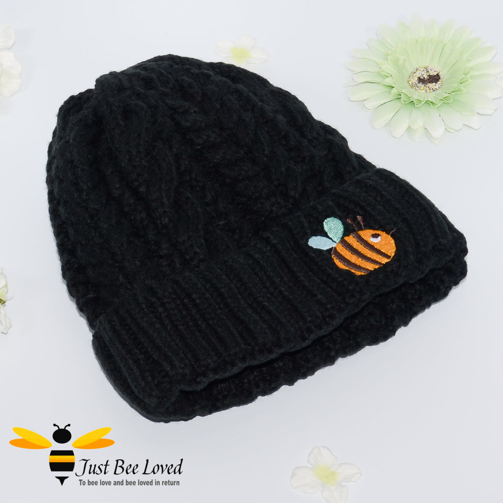 Aran style knitted hat with embroidery bee in black colour