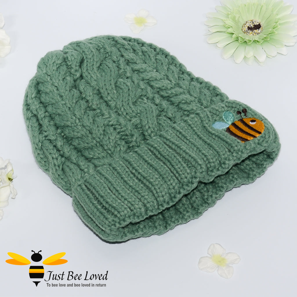 Aran style knitted hat with embroidery bee in green colour