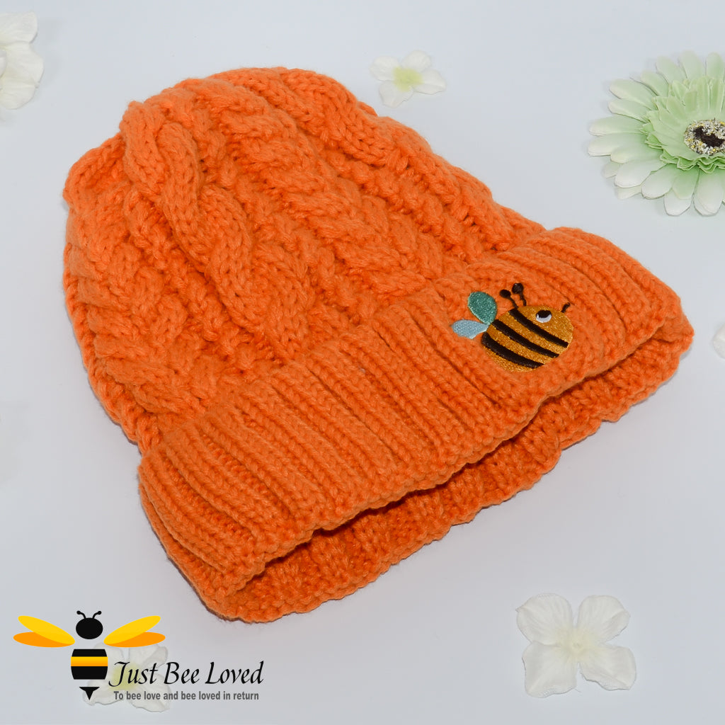 Aran style knitted hat with embroidery bee in orange colour