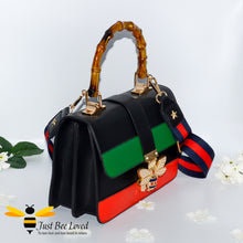 Load image into Gallery viewer, bamboo top handle handbag made with vegan friendly leather, featuring a large rhinestone crystal bee buckle embellishment