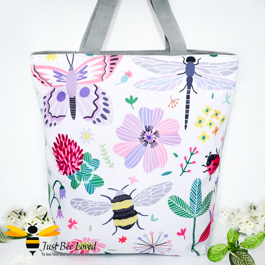 eco-friendly shopper tote bag featuring a colourful full frontal print design of pollinating insects amongst a floral display