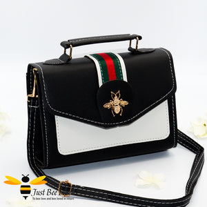 Black crossbody handbag with gold bee embellishment