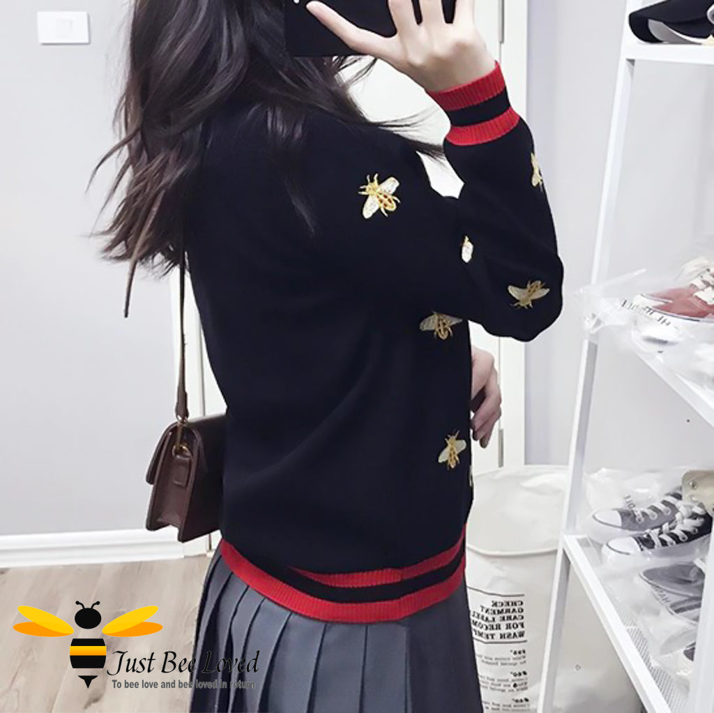 Woman wearing black bee cardigan