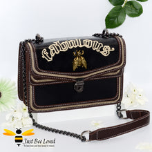 Load image into Gallery viewer, Rock chic styled vegan leather handbag featuring bold golden &quot;Fabulous&quot; embroidery with vintage gold bee embellishment in black colour.
