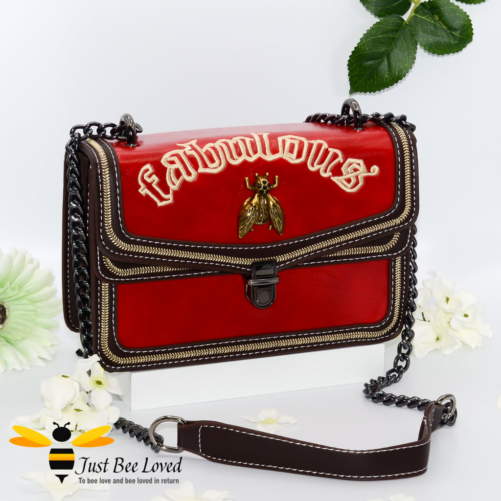 Rock chic styled vegan leather handbag featuring bold golden "Fabulous" embroidery with vintage gold bee embellishment in dark red colour.