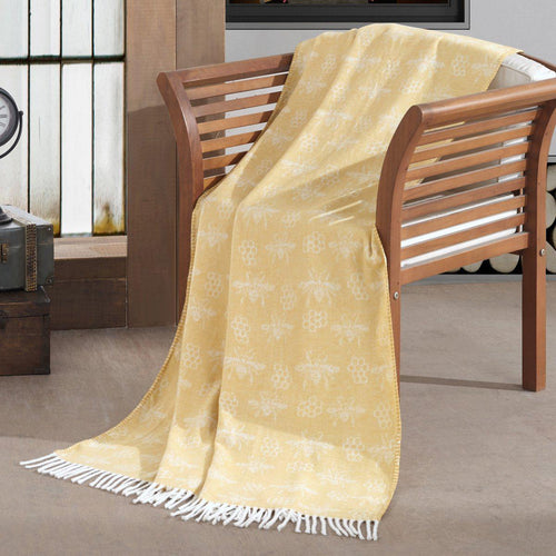 acrylic woollen throw blanket in pastel yellow featuring an all over honey bee & honeycomb design with fringe border