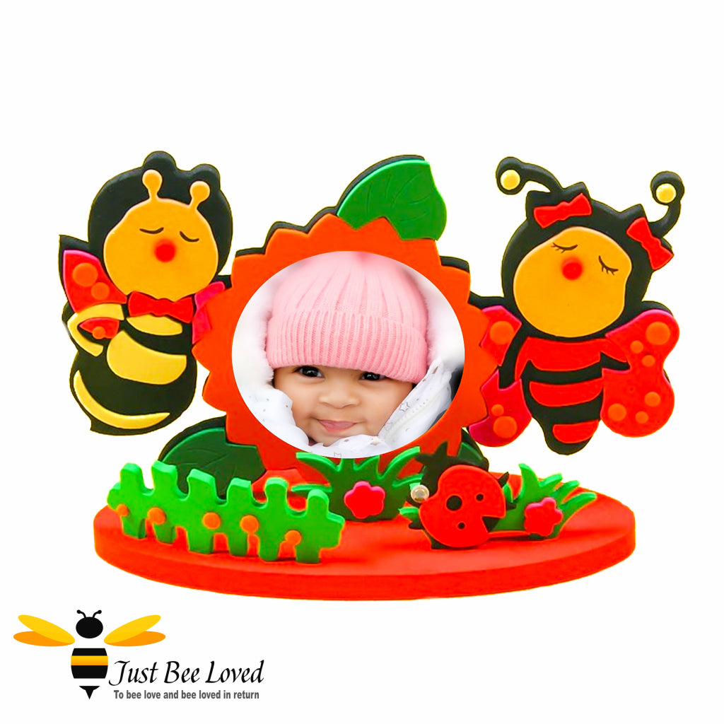 A DIY photo frame craft kit with two bumblebee figures and a space for a photo insert. The frame is designed to look like a garden.