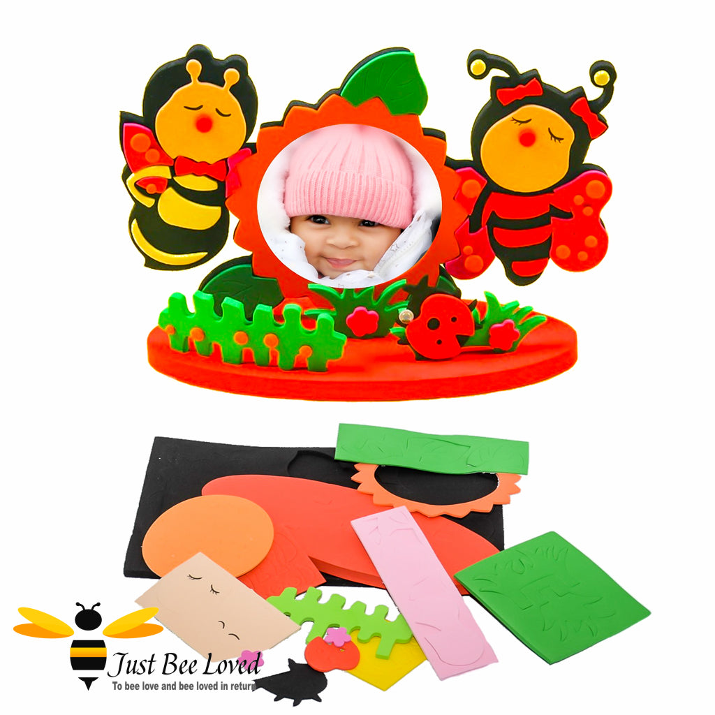 A DIY photo frame craft kit with two bumblebee figures and a space for a photo insert. The frame is designed to look like a garden.