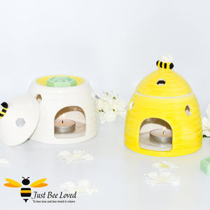 ceramic wax melt & oil burner designed in the shape of a beehive with removable lid featuring a honey bee