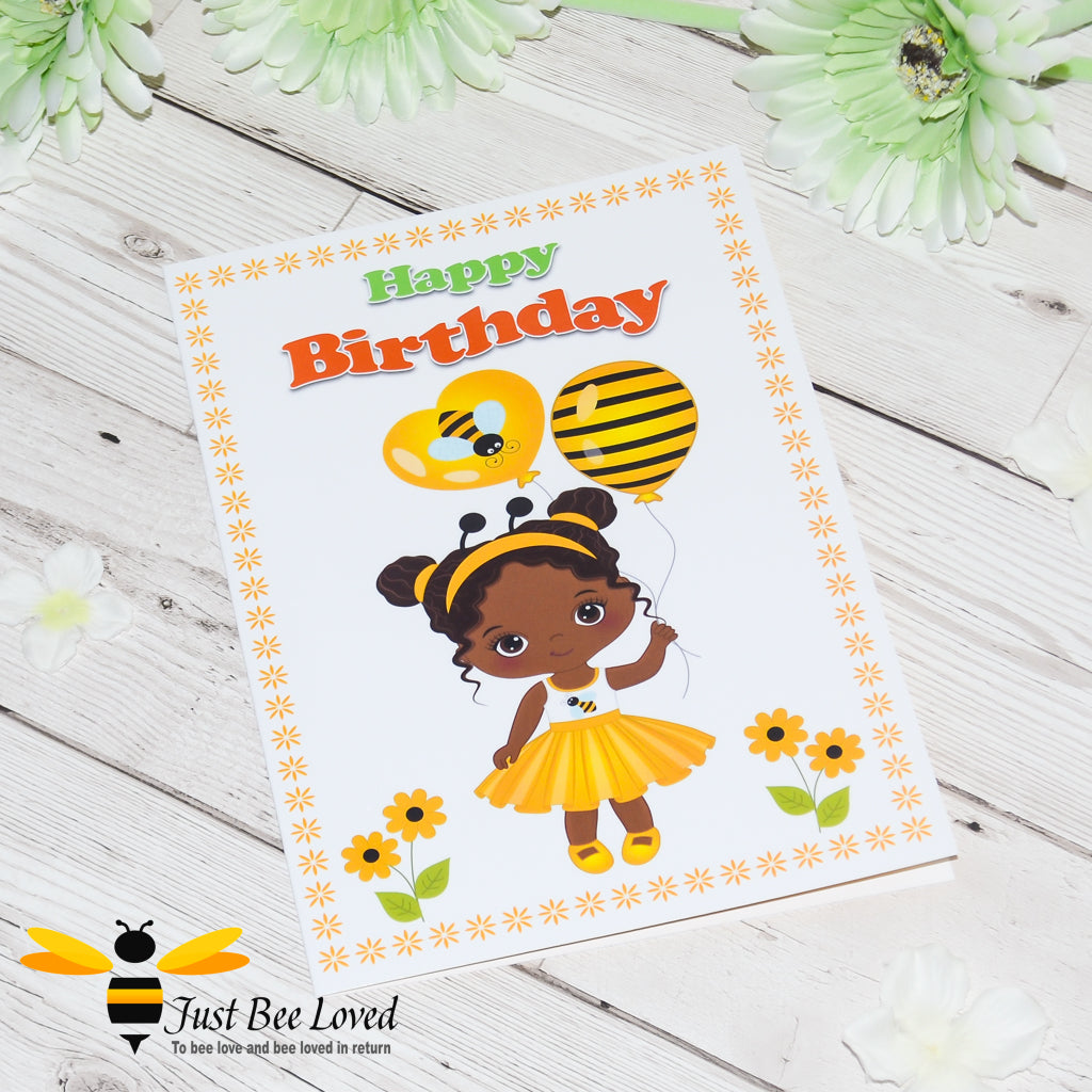 a birthday bee card featuring a cartoon illustration of a young black girl dressed in bee clothes and holding bee balloons.  