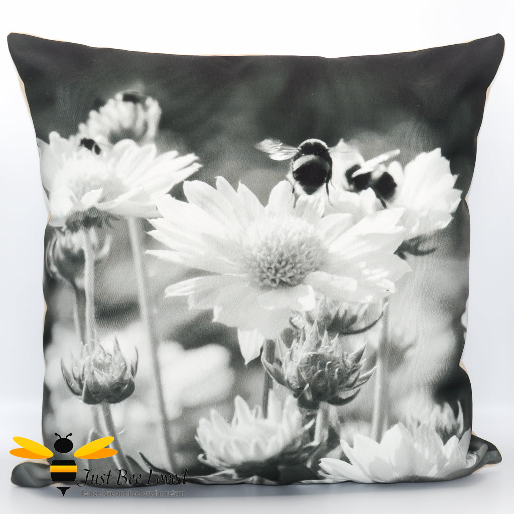 Black and white scatter cushion featuring a photographic image of bumblebees on daisy flowers.