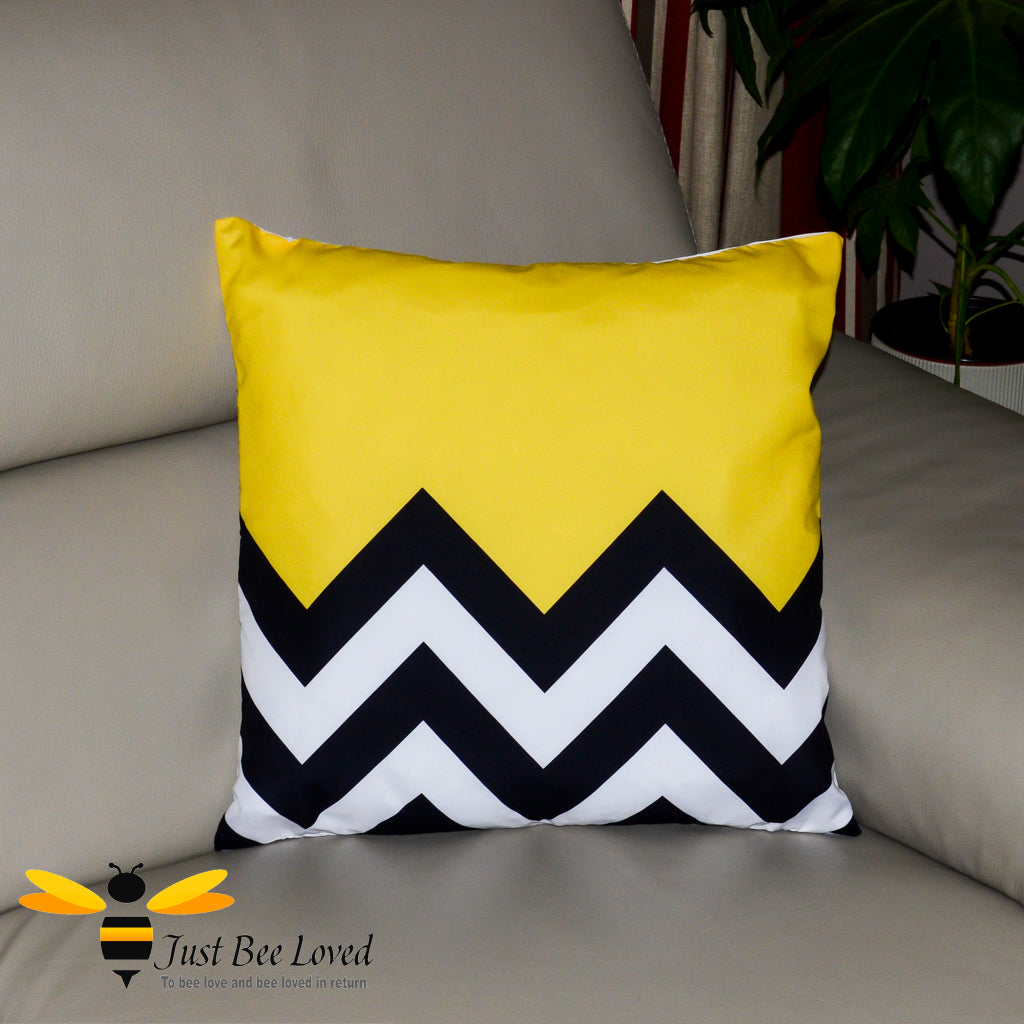 A black, yellow and white zig zag design scatter cushion.