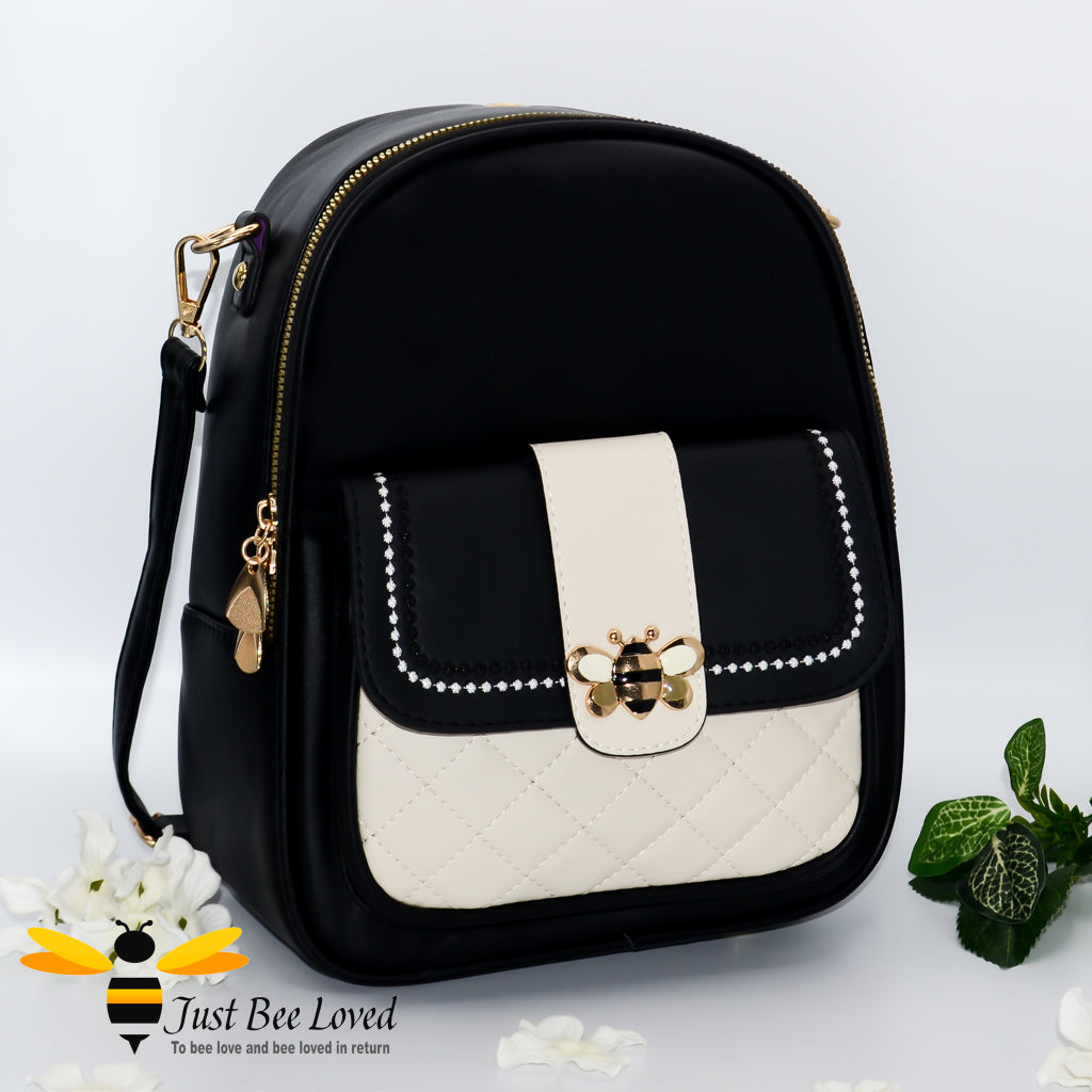 PU leather backpack featuring quilted flap-over front compartment with gold and cream bumblebee buckle clasp in black and cream colour