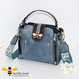 Flap over bumblebee two-toned vegan friendly leather handbag in sky blue colour.