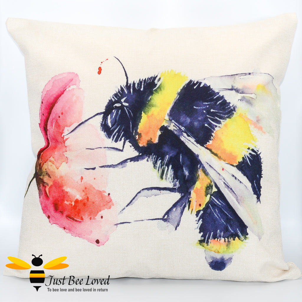 Cream cushion featuring a watercolour artwork design of a bumblebee foraging on wild poppy flower.