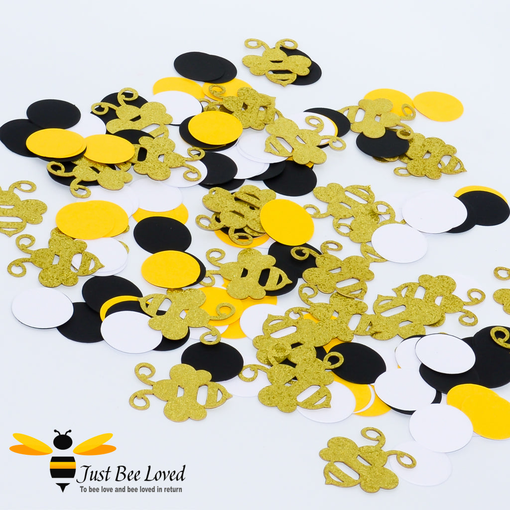 Bee themed table confetti decoration with yellow, white and black discs and gold glitter bees.