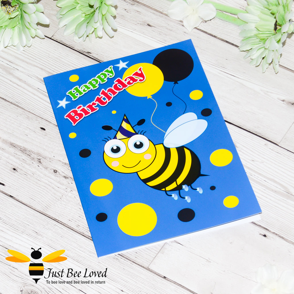 a birthday greeting bee card for young boy featuring cartoon bee with a party hat and yellow and black balloons on a blue background.