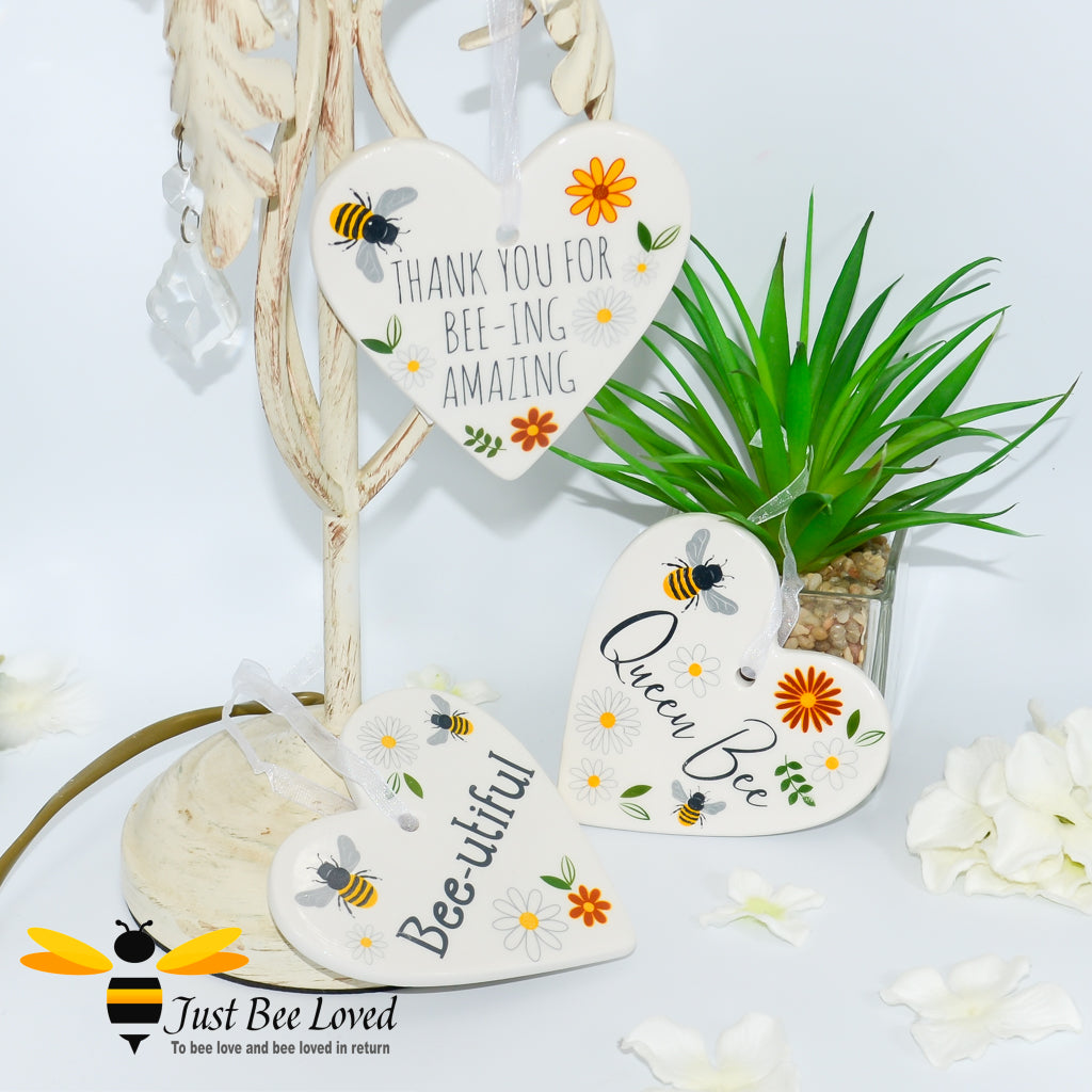 3 ceramic hanging heart plaques with bees and daisies with "queen bee" sentiment.