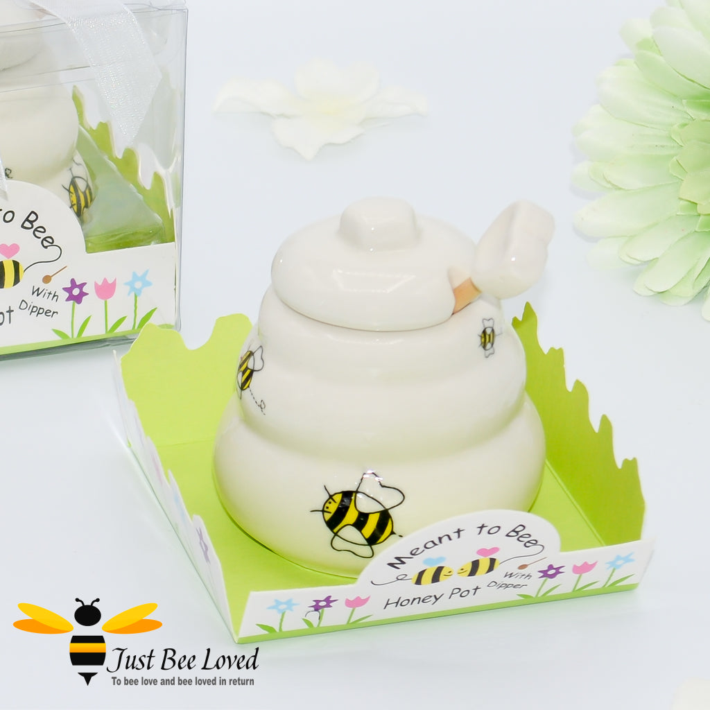 Ceramic hive shaped honey pot with dipper, decorated with bees in a gift box with 'meant to bee' text.