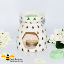 Load image into Gallery viewer, cream ceramic wax warmer &amp; oil burner featuring an all over print of bumblebees with honeycomb tea-light window