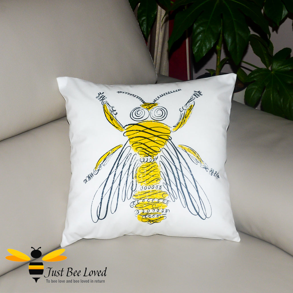 White scatter cushion featuring a contemporary sketch drawing of a yellow bee.