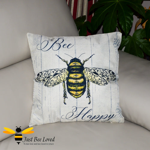 Cream coloured scatter cushion featuring a bumblebee with navy "Bee Happy" calligraphy.