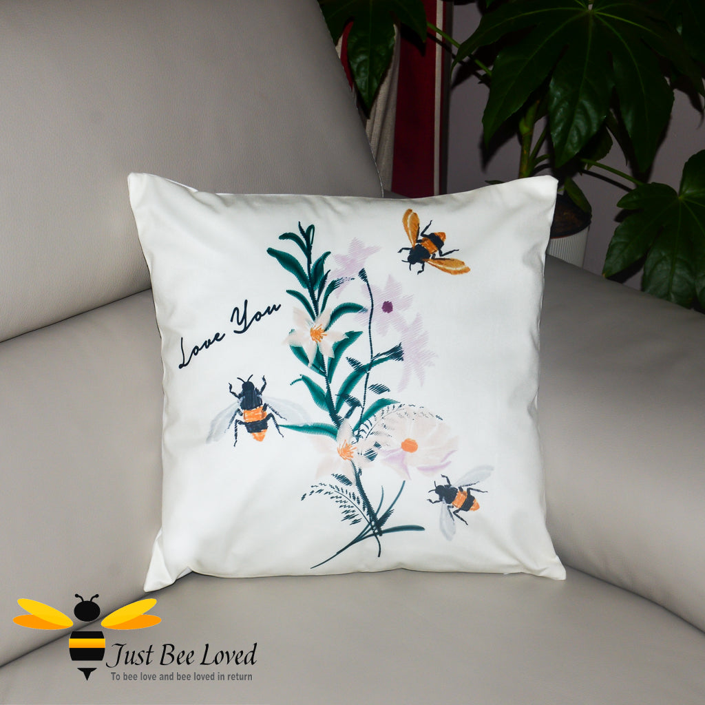 cream scatter cushion with embroidered effect image of bumblebees, flowers and "Love You" calligraphy.
