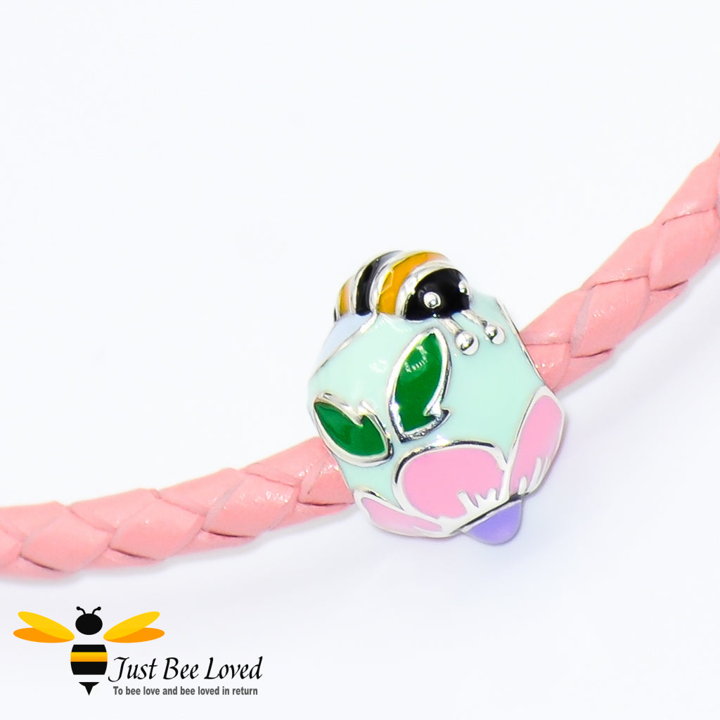 Braided pink leather bracelet featuring an enamelled sterling silver bee & flower charm bead