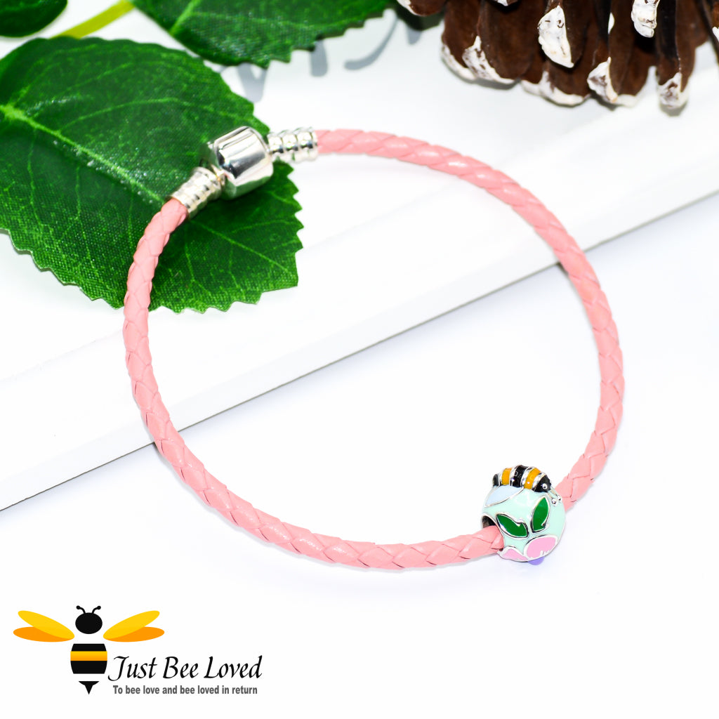 Braided pink leather bracelet with sterling silver clasp featuring an enamelled sterling silver bee & flower charm bead