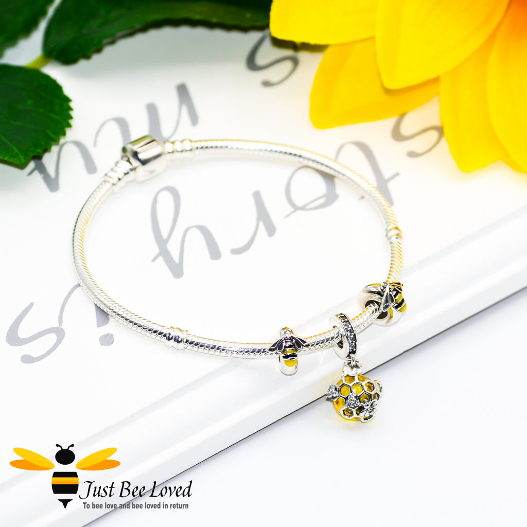 Sterling Silver snake charm bracelet with two enamelled silver bee charms and honeycomb crystal ball pendant