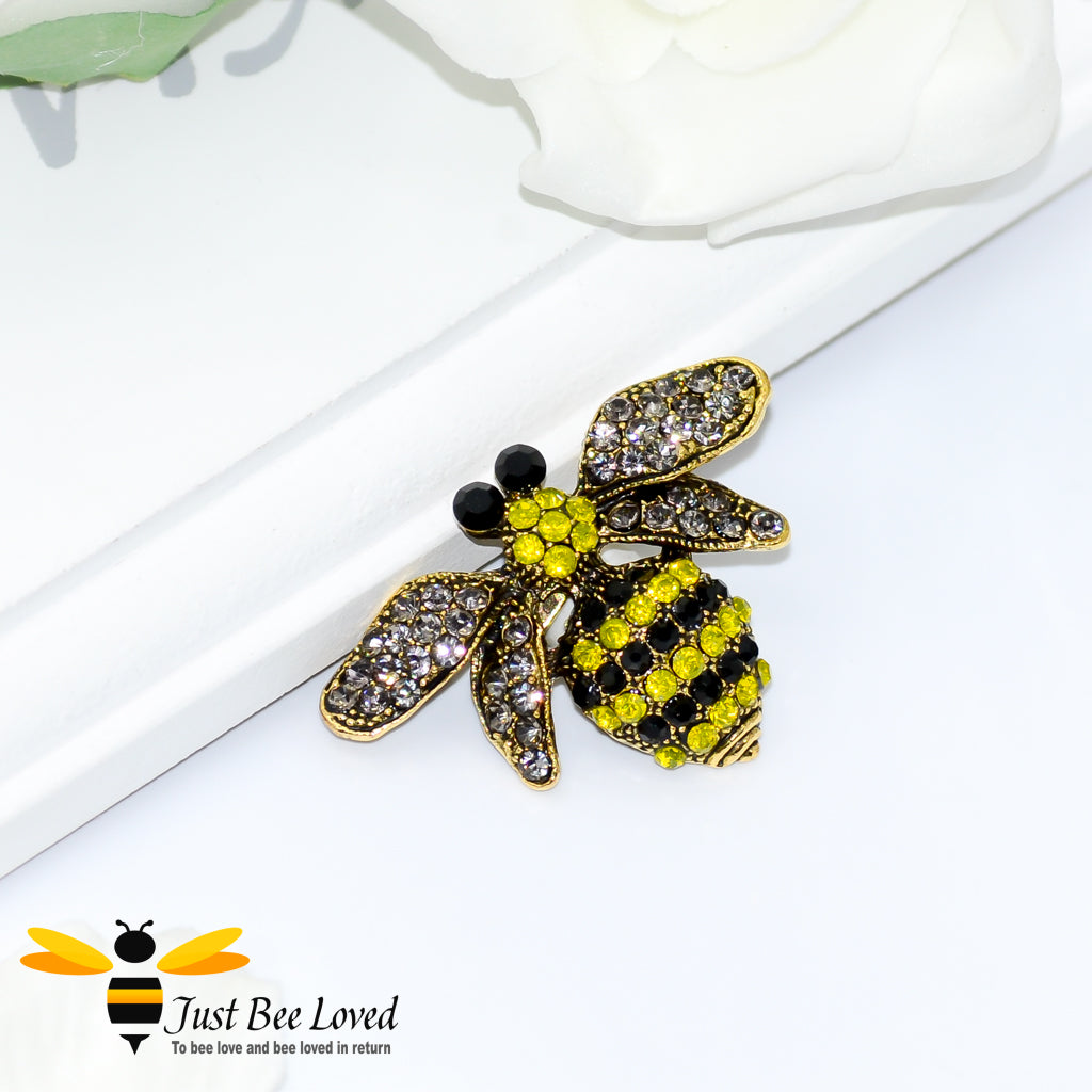 A vintage-style bumblebee brooch encrusted with white, yellow, and black rhinestone crystals.