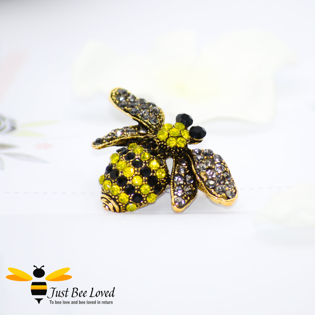 A vintage-style bumblebee brooch encrusted with white, yellow, and black rhinestone crystals.