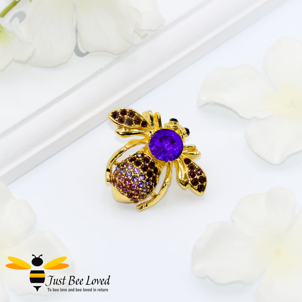 Gold plated bee brooch encrusted with purple coloured crystals