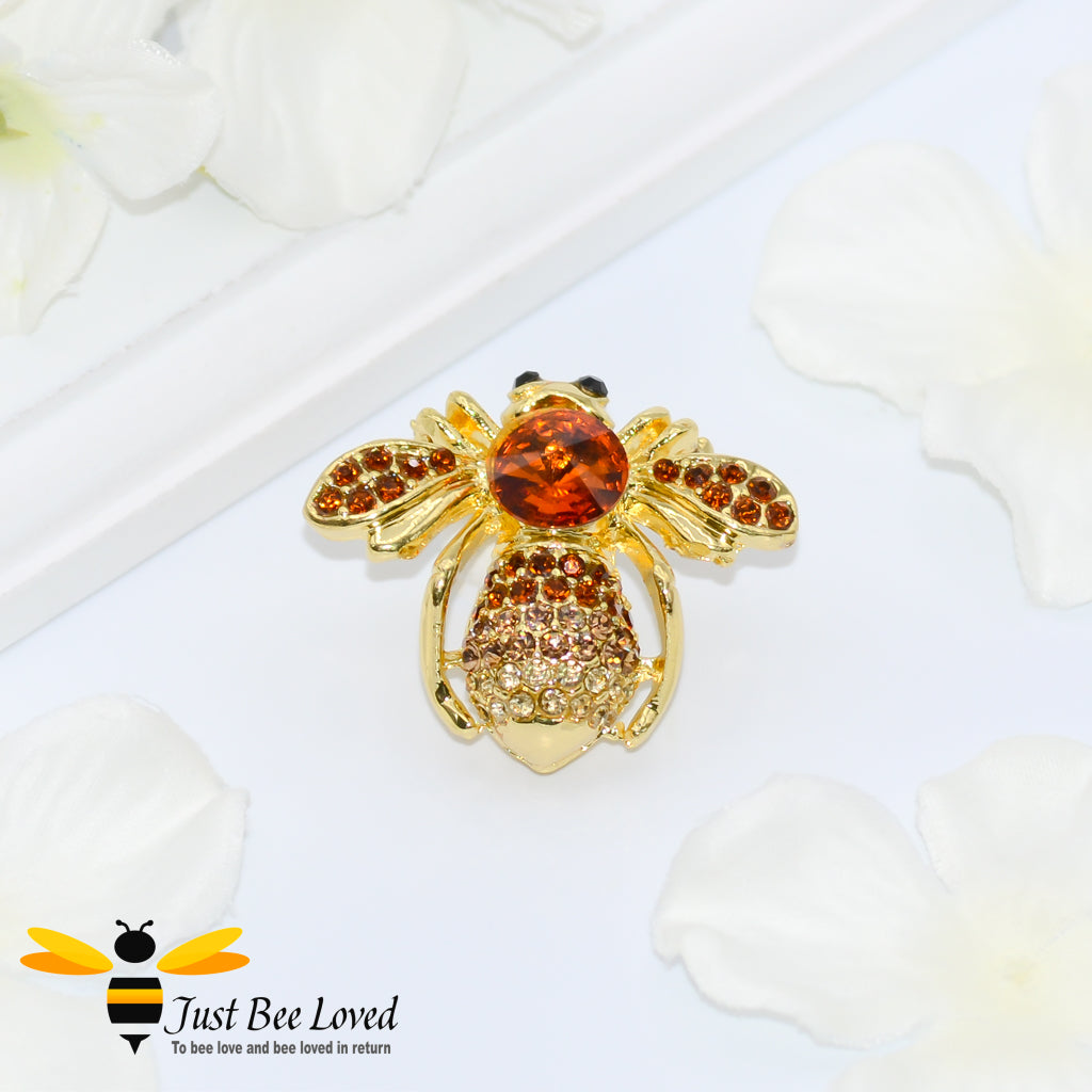 Gold plated bee brooch encrusted with orange coloured crystals