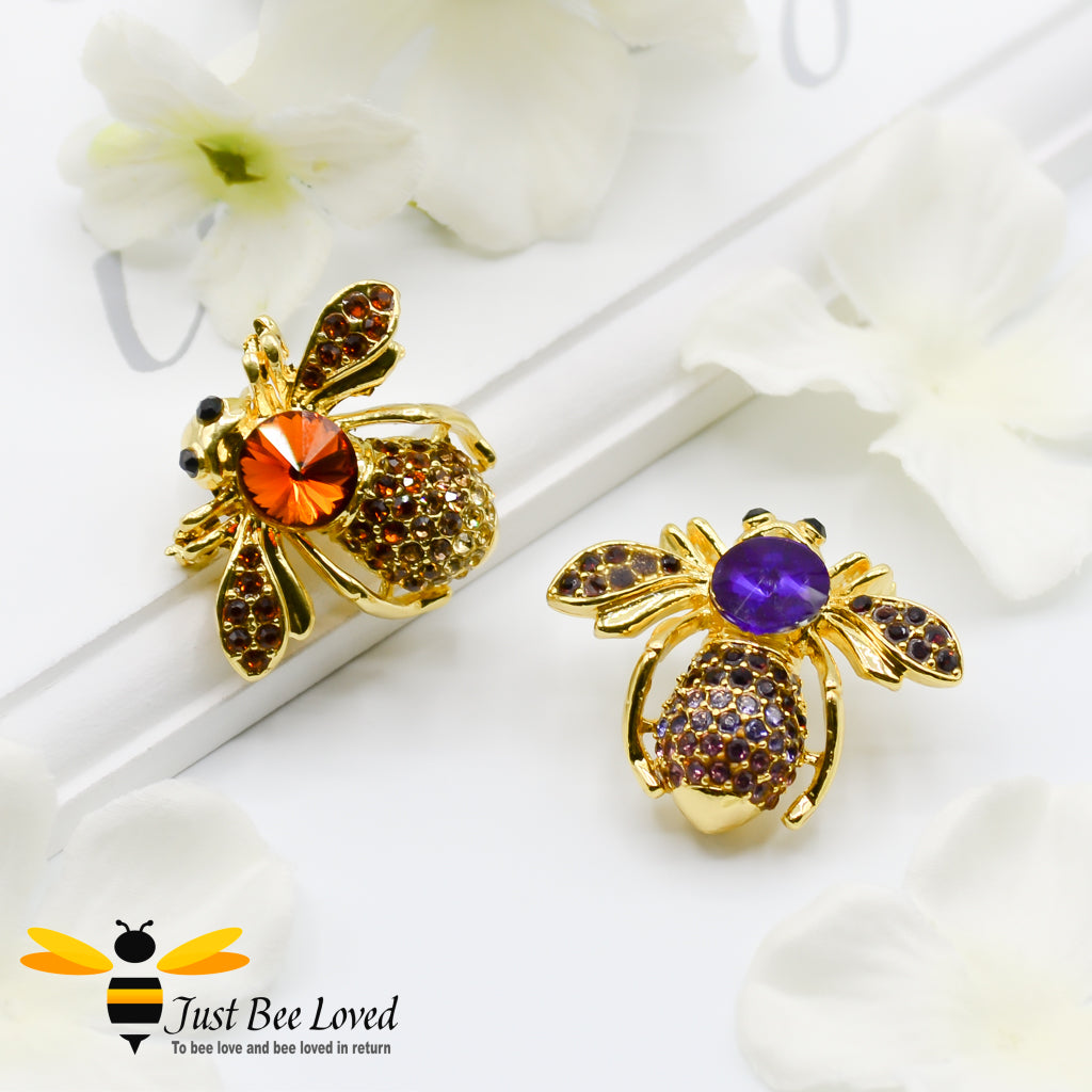 Gold plated bee-shaped brooch with multicolored rhinestone crystals with a pin safety lock.