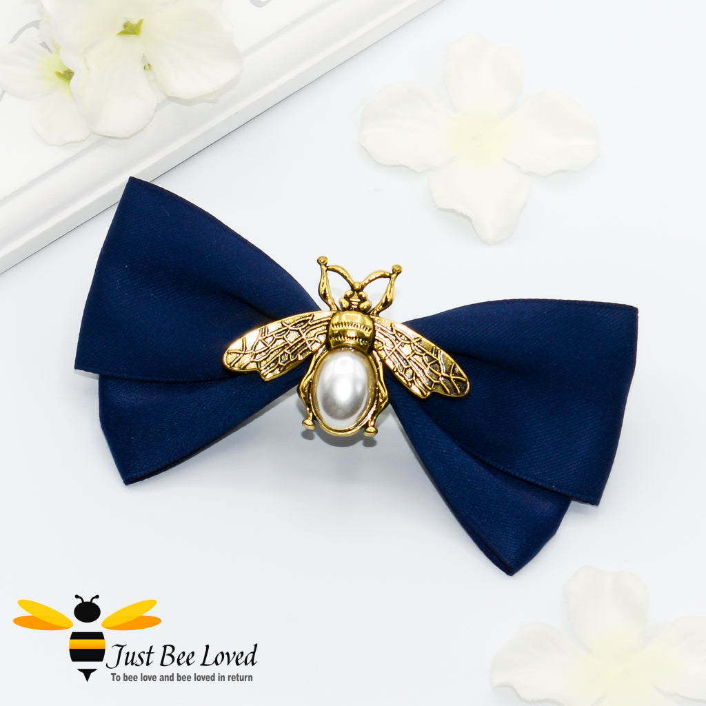 Women's hair bow clip with gold and pearl bee in navy.