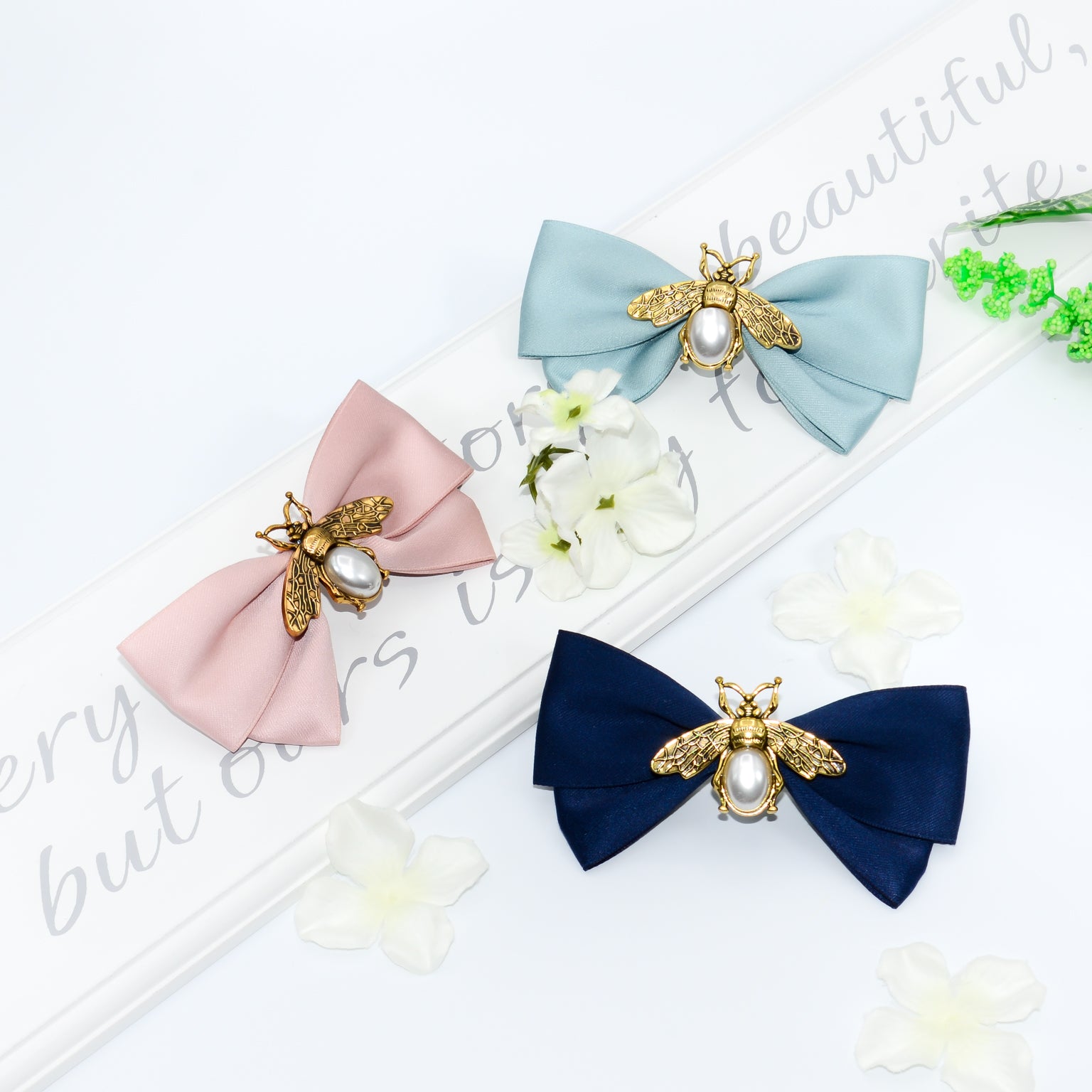 Women's hair bow clip with gold and pearl bees in navy, green and pink