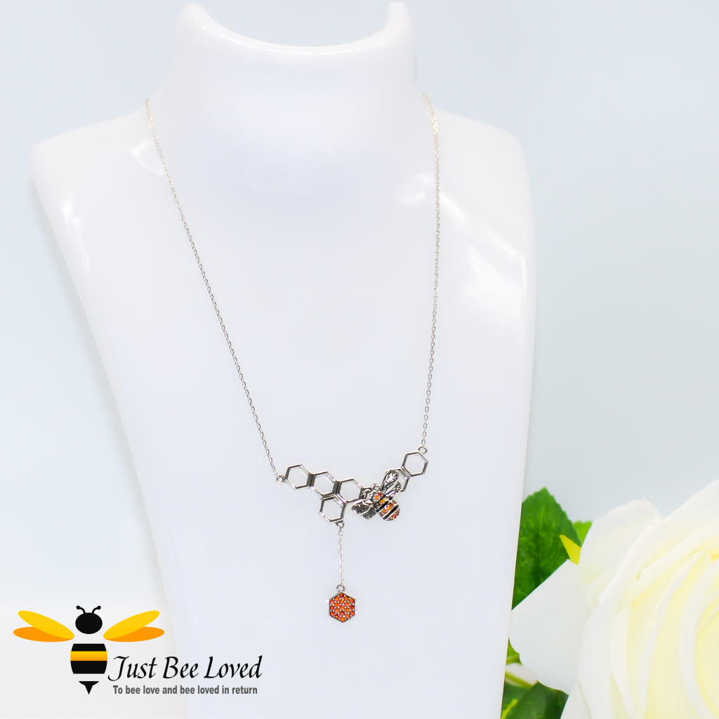 Sterling Silver necklace featuring a honeycomb dangle with a honey bee inlaid with orange and black crystals