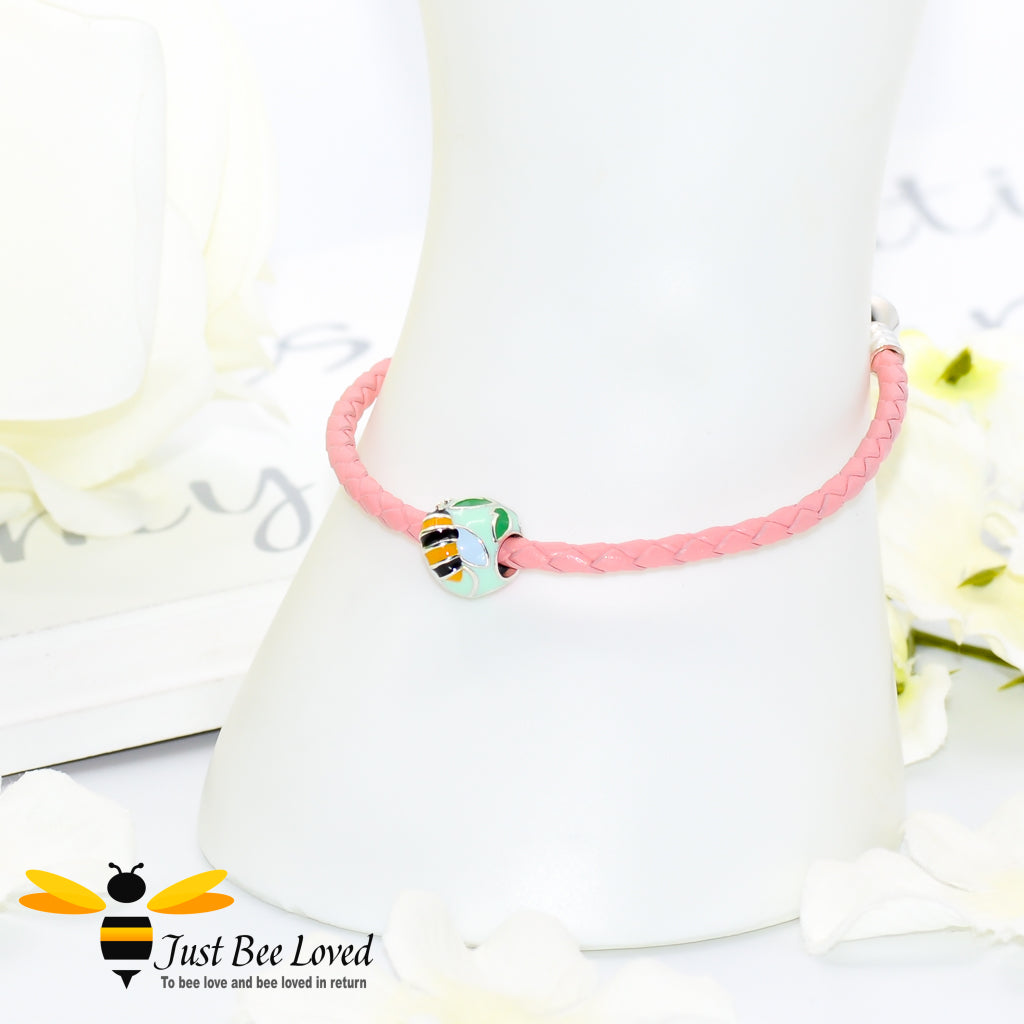 Braided pink leather bracelet featuring an enamelled sterling silver bee & flower charm bead